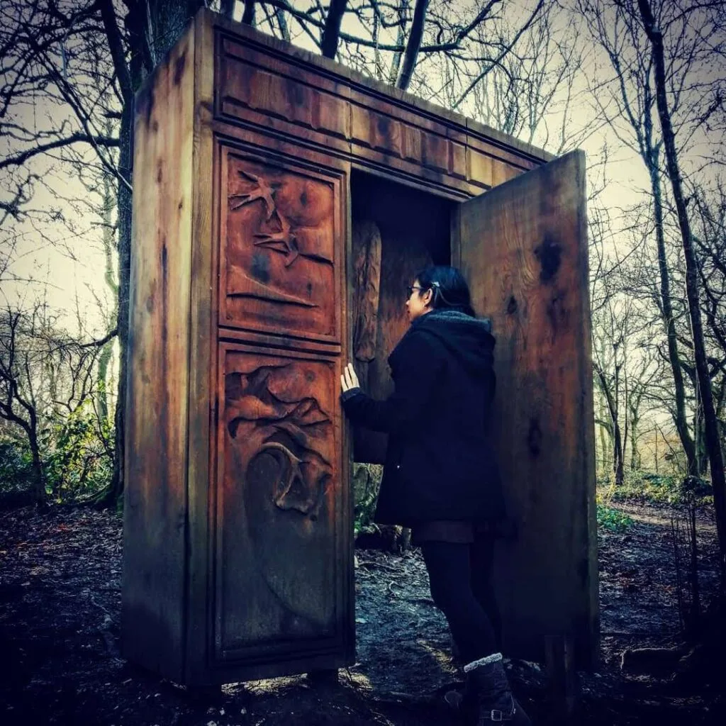Amy V. Borg steps through a wardrobe in a mysterious woodland.