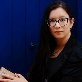 A profile photo of fantasy author Amy V. Borg: she is a dark haired woman with glasses.