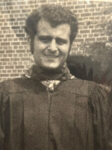 Photo of my father at his graduation many years ago, with dark, curly hair, clean-shaven and smiling.
